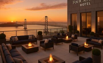 Panoramic rooftop view at Four Seasons Hotel San Francisco capturing the Bay Bridge and cityscape during golden hour