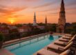 Hotel Bennett rooftop pool overlooking Charleston skyline at sunset