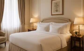 Luxury hotel room at Hotel Drisco featuring serene decor and plush bedding