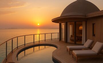 Luxury overwater bungalow at Nujuma Ritz-Carlton Reserve with Red Sea sunset