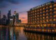 The Fullerton Bay Hotel exterior with waterfront glow and city skyline