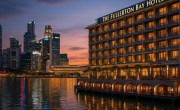 The Fullerton Bay Hotel exterior with waterfront glow and city skyline