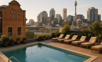 Rooftop pool at The Old Clare Hotel with city skyline in the background