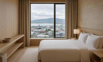 Serene minimalist hotel room at The Reykjavik EDITION with natural elements and Reykjavik view