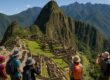 Panoramic Machu Picchu with tourists and green mountains
