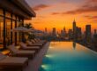 Rooftop pool with city skyline at sunset
