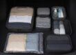 Organized packing cubes and compressed luggage in car trunk