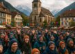 Festival attendees at a cool-climate town with snow or alpine backdrop