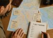 Traveler planning a 7-day travel itinerary with maps and notes