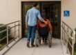 Couple entering accessible hotel entrance with ramp