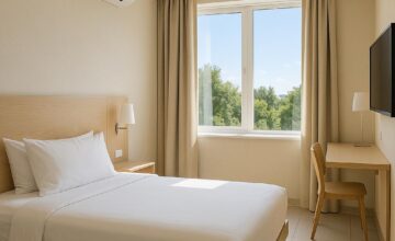 Budget hotel room with air conditioning and bright windows