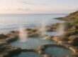 Calm coastal hot spring setting at sunset