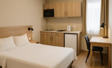 Budget aparthotel room with kitchen and workspace